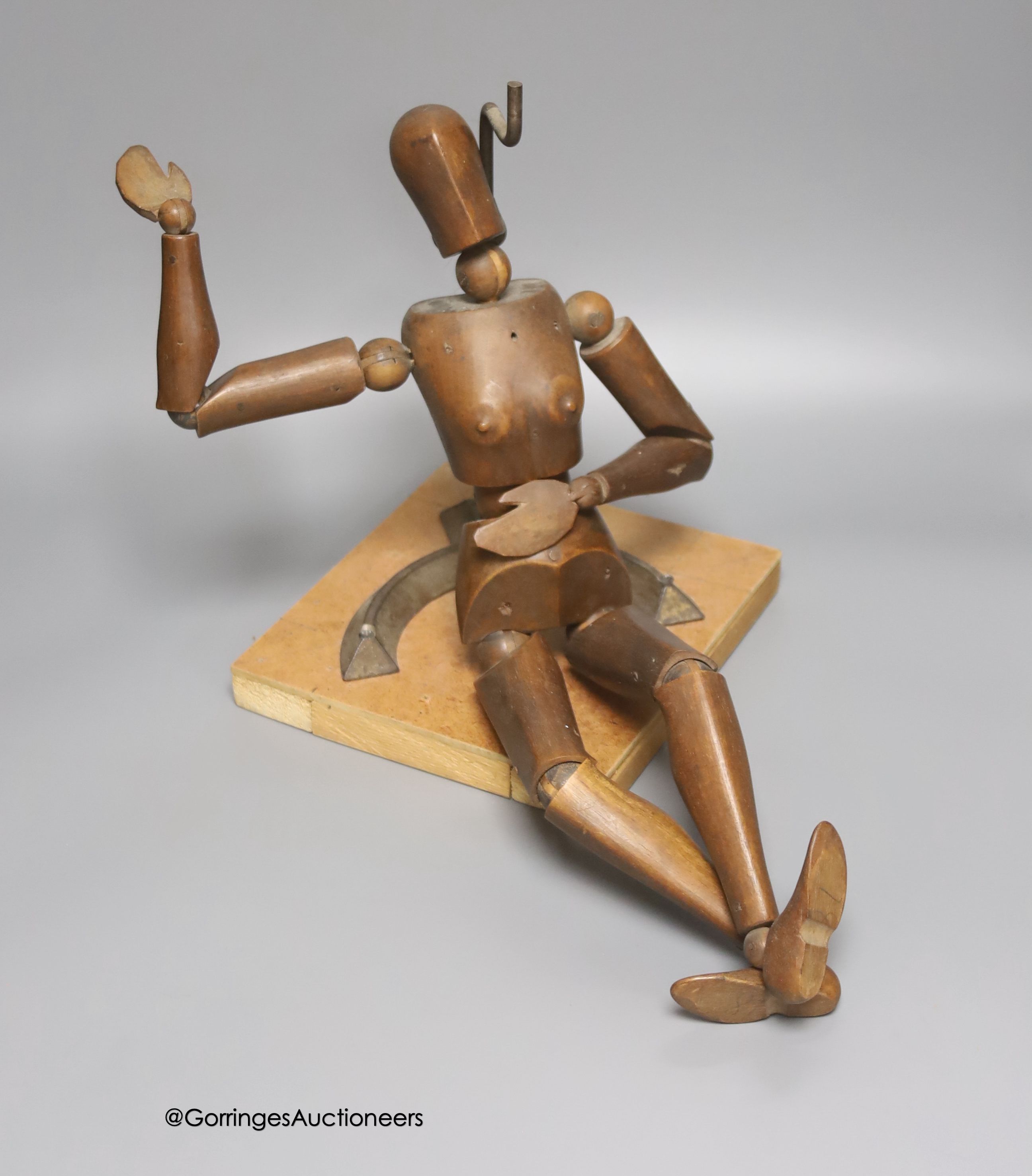 A late 19th century carved beech lay figure, on cast metal stand, height 38cm